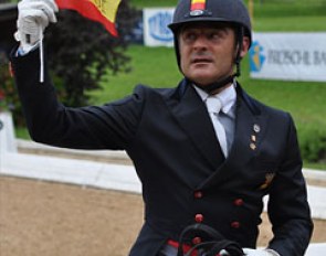 Juan Manuel Munoz Diaz waves a Spanish flag on which "ANIMO JORDI" is written to support team mate Jordi Domingo who lost his number one Grand Prix horse Prestige the week before