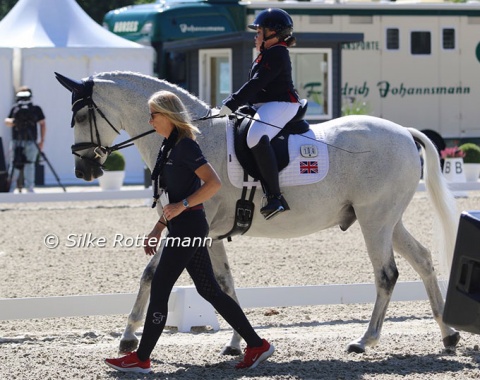 Oozing charme: Strong Beau put in a stellar performance in the individual competition to win an unexpected bronze medal for his rider Gabriella Blake. Here they are led into the ring by home trainer Nicola Lickley 