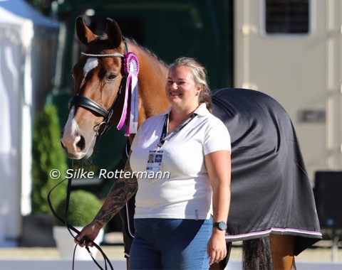 King of the Dance seemed to share his rider’s joy. Groom Karina Krauze is no less delighted about another gold medal.