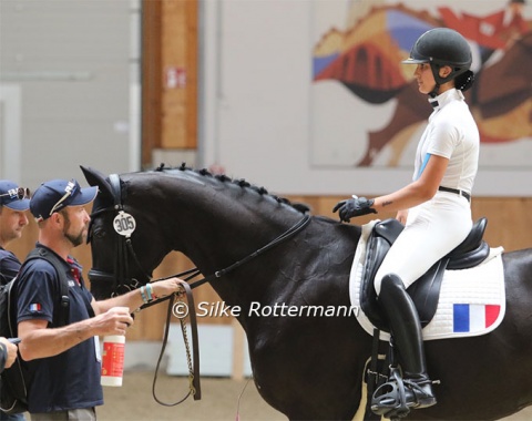 Serious face at the ever-smiling Chiara Zenati before her start with Swing Royal IFCE who gets some fly spray before ging outside.
